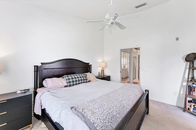 bedroom with a ceiling fan, light colored carpet, and visible vents