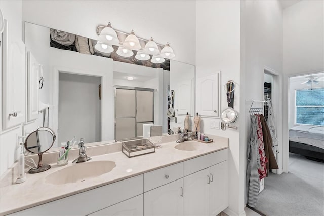 bathroom featuring a sink, double vanity, a shower stall, and ensuite bathroom