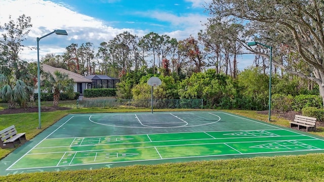 view of sport court with a yard, community basketball court, and fence