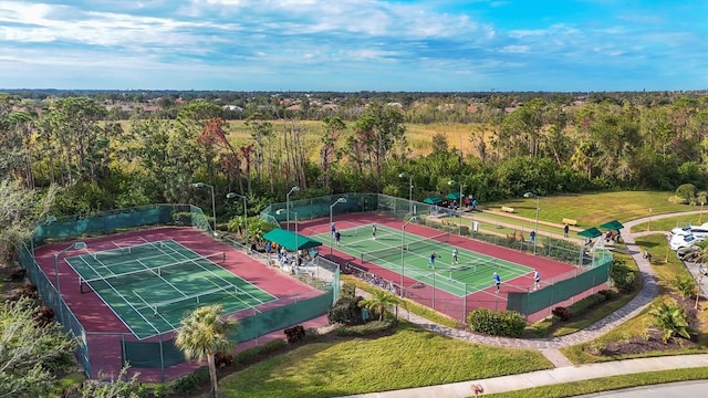 bird's eye view with a wooded view