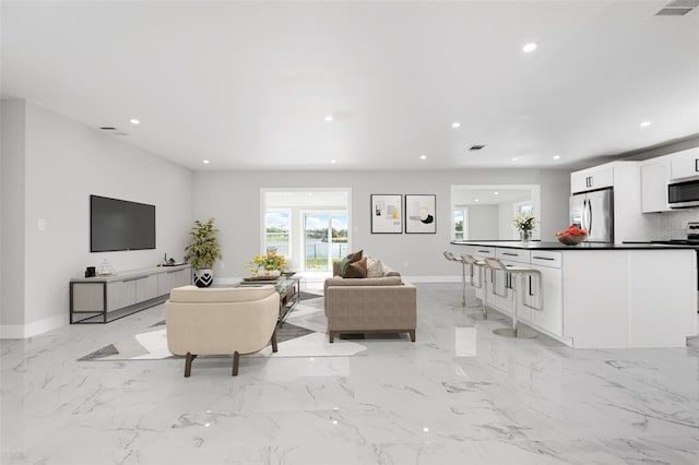 living room featuring visible vents, recessed lighting, marble finish floor, and baseboards