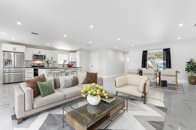 living room featuring visible vents, recessed lighting, marble finish floor, and baseboards