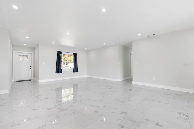 empty room featuring recessed lighting, baseboards, visible vents, and marble finish floor