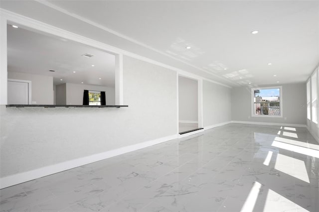 unfurnished living room with recessed lighting, marble finish floor, and baseboards