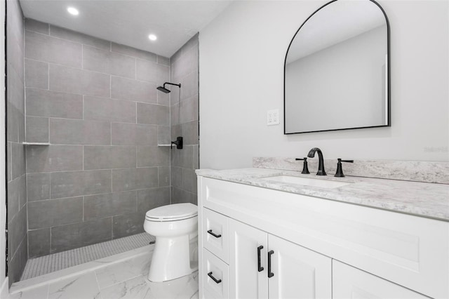 bathroom with vanity, recessed lighting, a tile shower, toilet, and marble finish floor