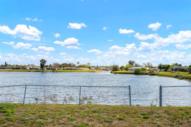 property view of water featuring fence