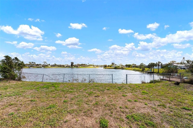 property view of water featuring fence