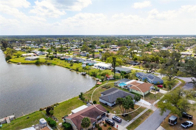 birds eye view of property with a residential view and a water view