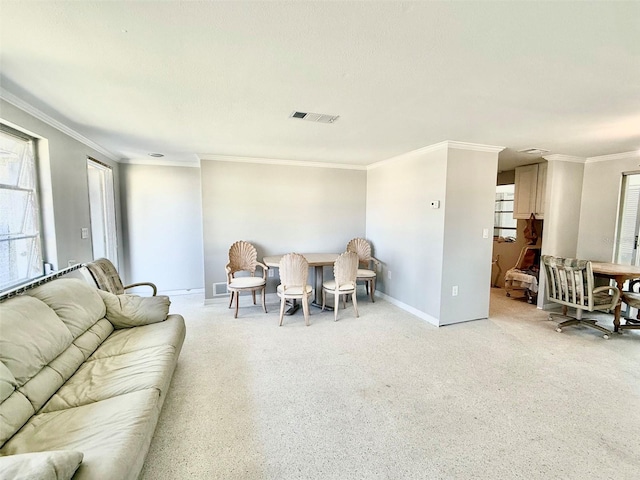 living room featuring ornamental molding, visible vents, and baseboards