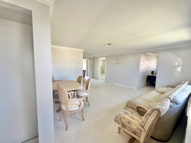 dining area with baseboards, ornamental molding, visible vents, and an inviting chandelier