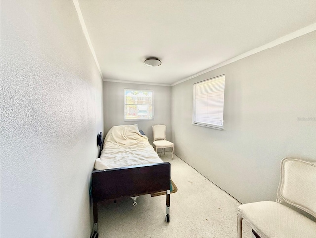 bedroom with a textured wall and ornamental molding