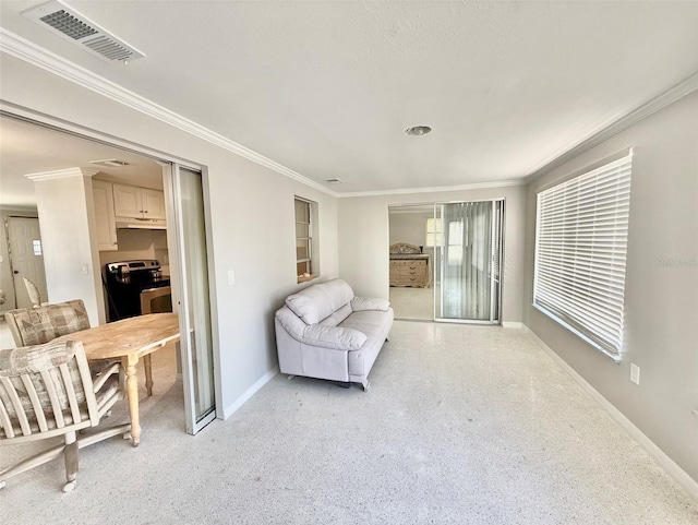 sitting room featuring baseboards, visible vents, light speckled floor, and crown molding