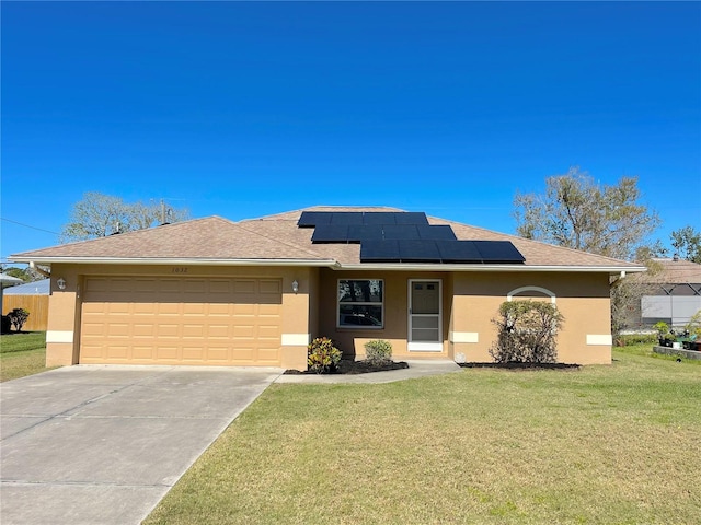 single story home featuring a front lawn, concrete driveway, roof mounted solar panels, stucco siding, and a garage