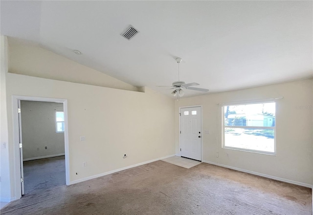 entrance foyer with visible vents, plenty of natural light, light colored carpet, and lofted ceiling