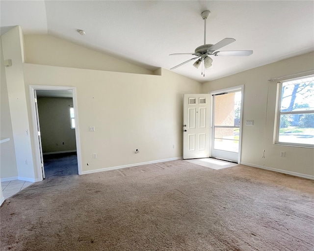 spare room featuring baseboards, lofted ceiling, and light colored carpet