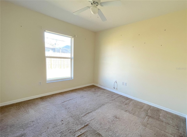 unfurnished room featuring baseboards, carpet, and ceiling fan