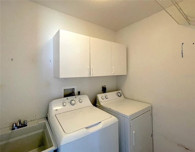 laundry room with a sink, cabinet space, and independent washer and dryer