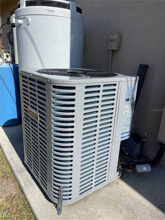 exterior details featuring cooling unit and stucco siding