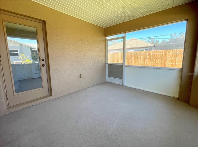 unfurnished sunroom with wood ceiling