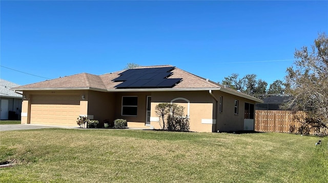 single story home with stucco siding, solar panels, a front yard, and fence