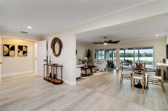 dining room with visible vents, baseboards, recessed lighting, a water view, and light wood-type flooring