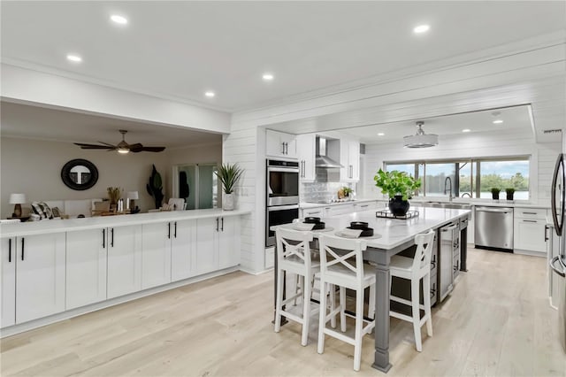 dining room with ornamental molding, recessed lighting, light wood finished floors, and ceiling fan