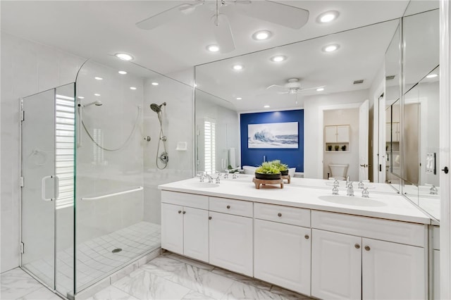 bathroom featuring a sink, marble finish floor, a shower stall, and a ceiling fan