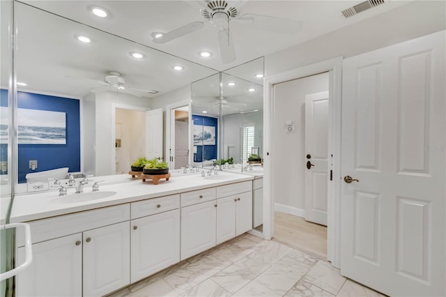 bathroom with a ceiling fan, visible vents, marble finish floor, and a sink