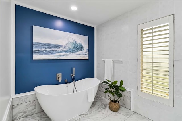 bathroom featuring recessed lighting, baseboards, a soaking tub, and marble finish floor