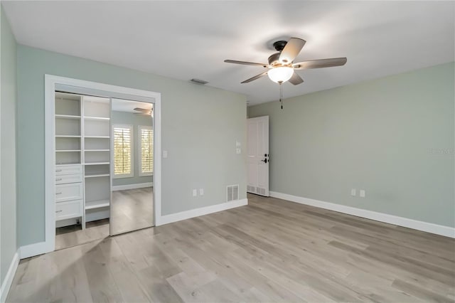 unfurnished bedroom with a ceiling fan, baseboards, visible vents, and light wood-type flooring