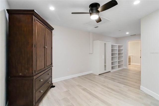 spare room with light wood finished floors, baseboards, and ceiling fan