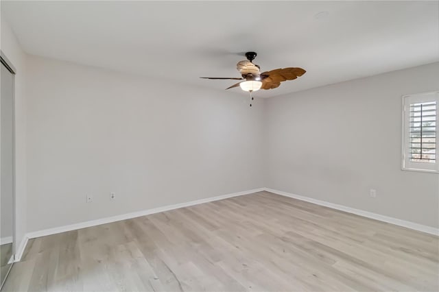 empty room featuring light wood-type flooring, baseboards, and ceiling fan