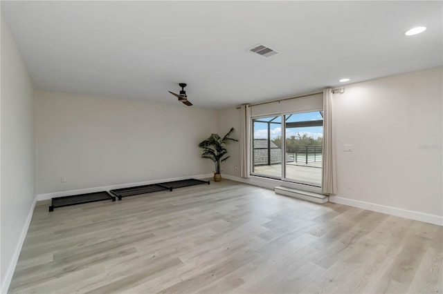 empty room with recessed lighting, light wood-style floors, visible vents, and baseboards