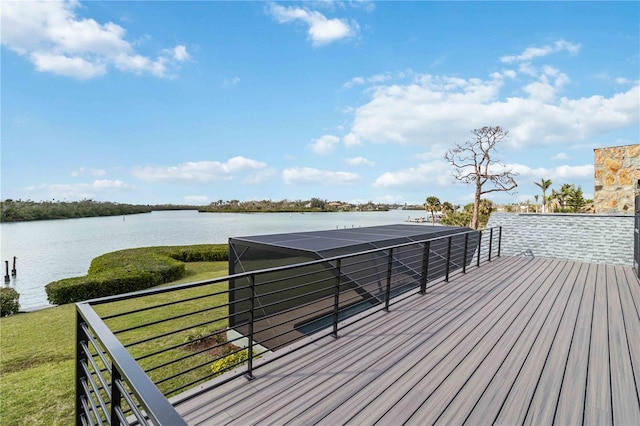 deck with a yard and a water view