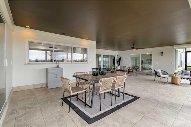 view of patio with outdoor dining space, an outdoor living space, a sink, and ceiling fan