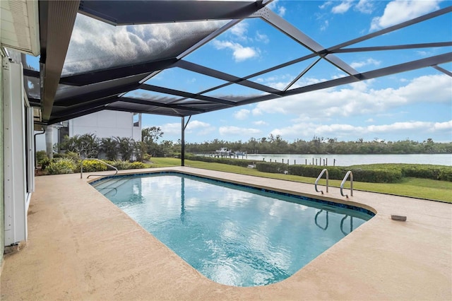 outdoor pool featuring a yard, glass enclosure, a patio, and a water view