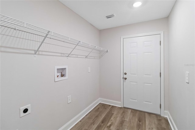 laundry room with wood finished floors, visible vents, hookup for an electric dryer, laundry area, and washer hookup