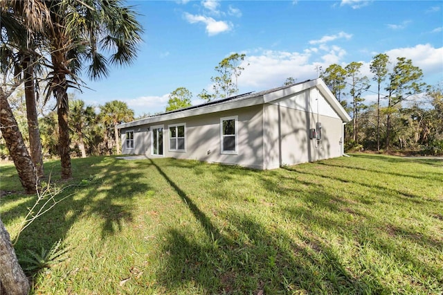 rear view of property with a lawn