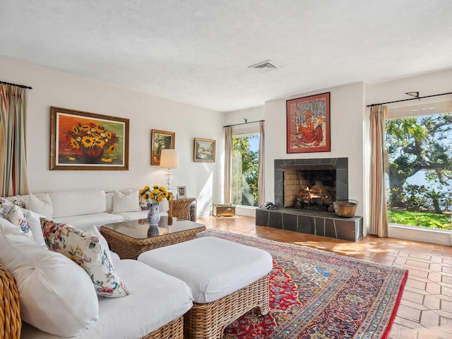 living area with a fireplace and visible vents