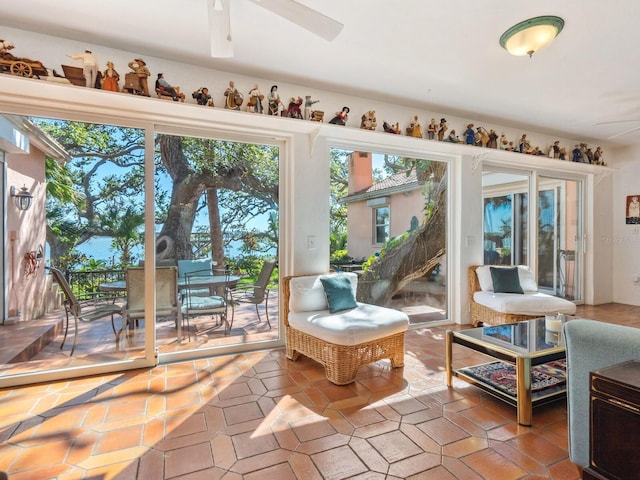 sunroom / solarium featuring ceiling fan