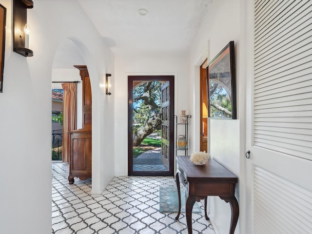 doorway to outside featuring arched walkways