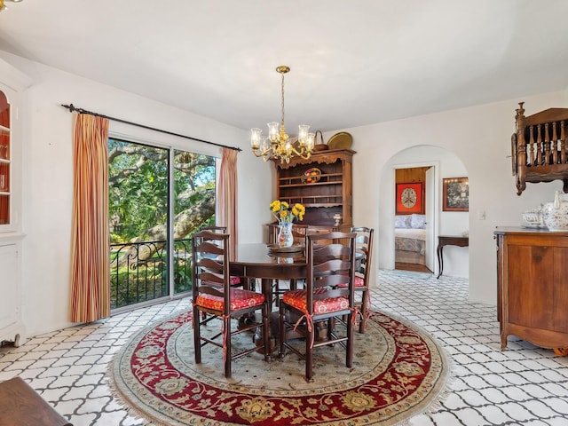 dining room featuring arched walkways and a notable chandelier