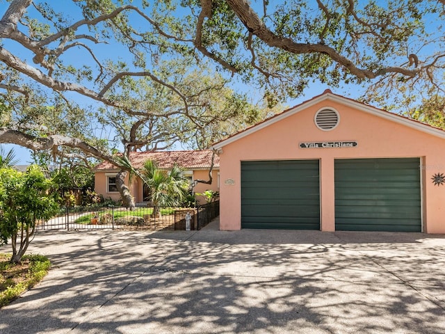 garage with driveway and fence