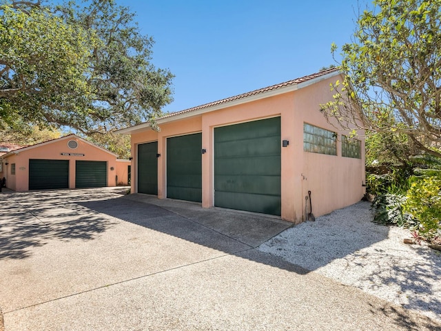 garage with concrete driveway