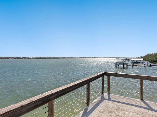 dock area with a balcony and a water view