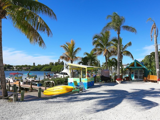 view of playground with a boat dock and a water view