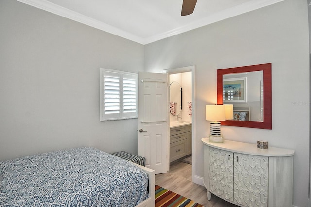 bedroom with light wood-type flooring, a ceiling fan, connected bathroom, and crown molding