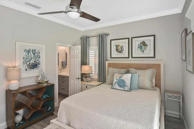 bedroom with visible vents, ensuite bath, wood finished floors, and ornamental molding