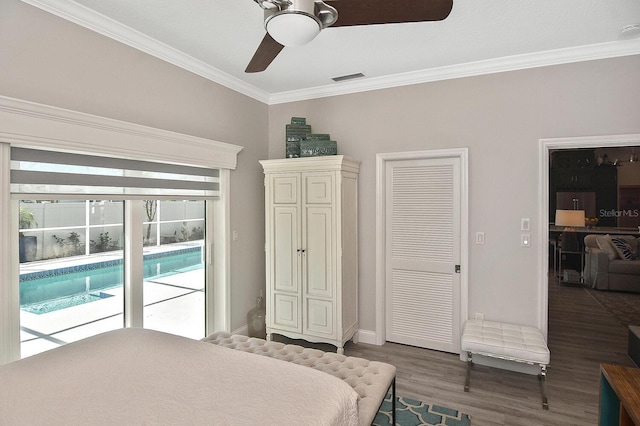 bedroom featuring access to exterior, visible vents, crown molding, and wood finished floors