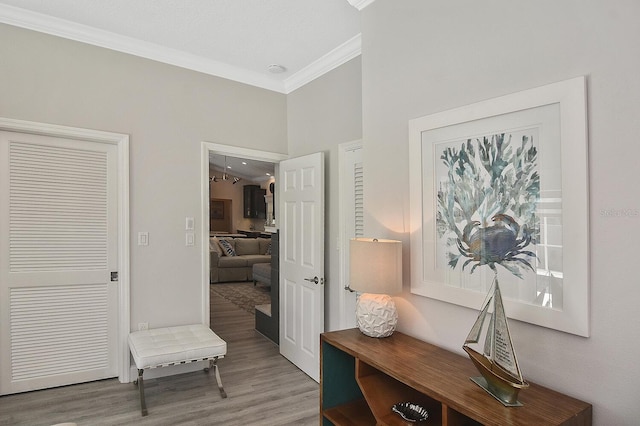 interior space with ornamental molding and wood finished floors